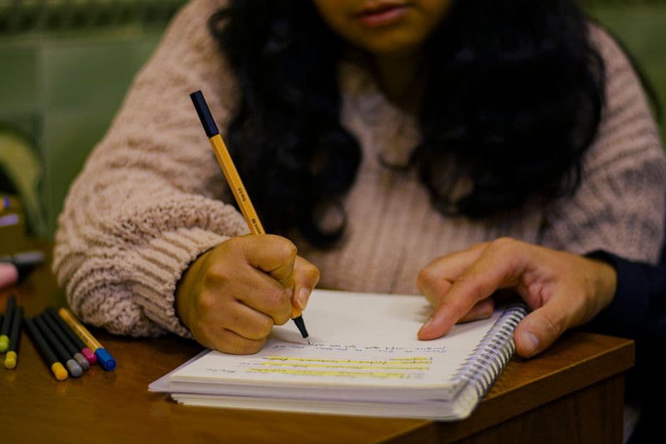 A teenager journaling at a desk